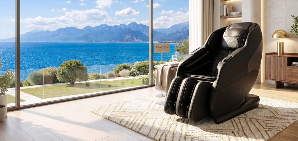 Black Daiwa iLift massage chair by a floor-to-ceiling window with an ocean and mountain view. From Wish Rock Relaxation.