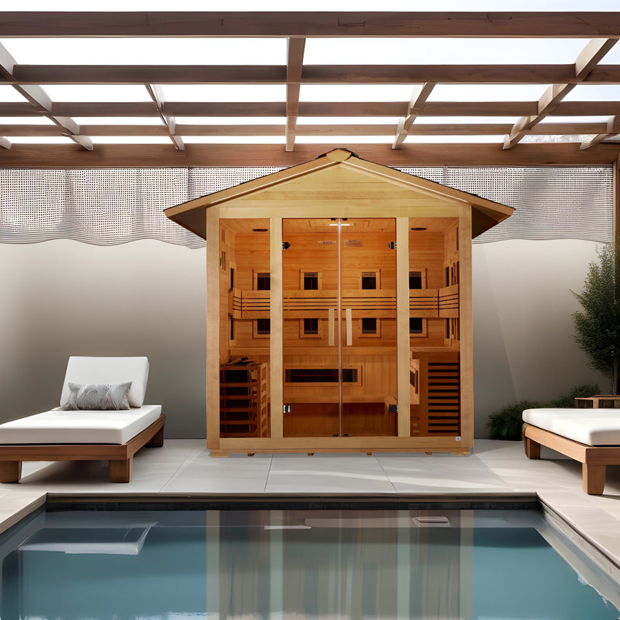 Golden Designs "Gargellen" 5 Person Hybrid Outdoor Sauna in Canadian hemlock placed poolside under a pergola from Wish Rock Relaxation