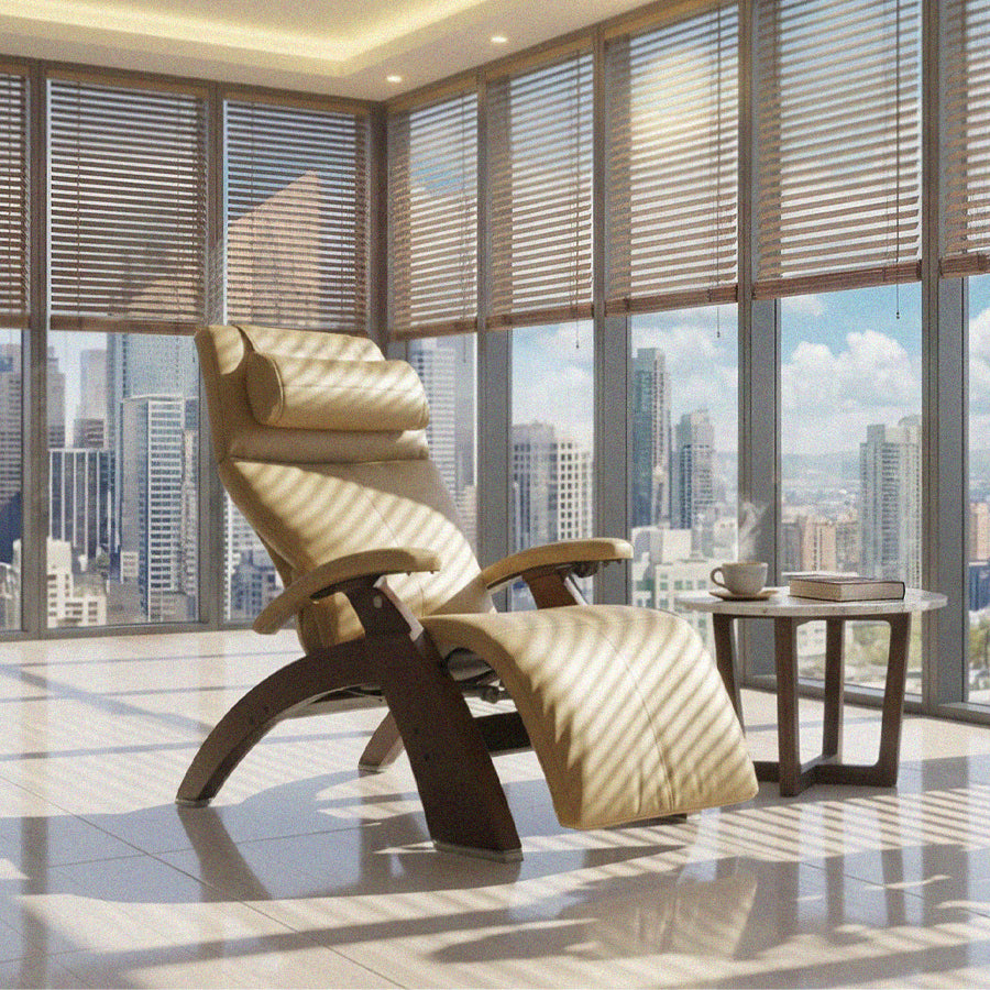 Human Touch Perfect Chair PC-610 Zero Gravity Chair in beige reclining in a sunlit high-rise living space with city view from Wish Rock Relaxation