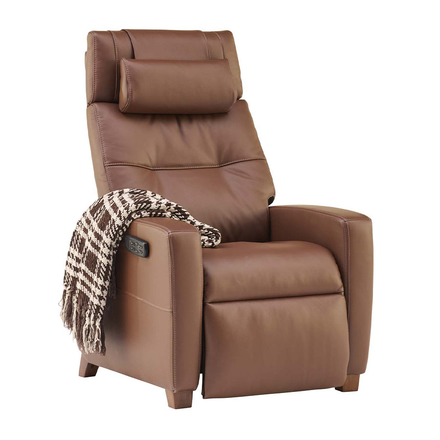 Human Touch Vesta Zero Gravity chair in chestnut with decorative throw blanket over armrest.