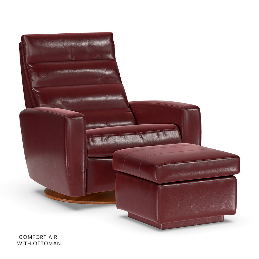 American Leather Lanier Comfort Air chair in burgundy with matching ottoman on wooden disc base.