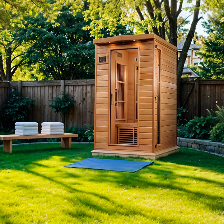 Maxxus 2 Person Near Zero EMF FAR Infrared Sauna - Canadian Hemlock shown in a serene backyard setting, featuring full-spectrum infrared panels, natural wood construction, and glass door design from Wish Rock Relaxation.