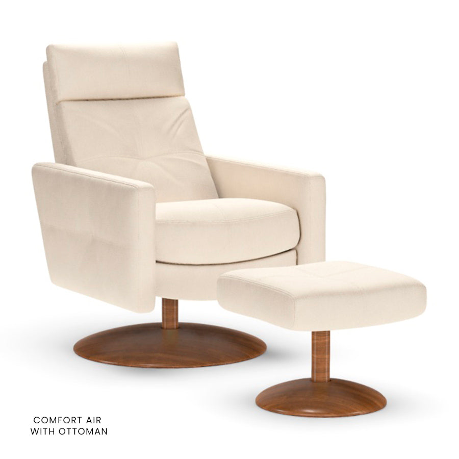 American Leather Rainier Comfort Air chair in cream with matching ottoman on wooden disc base.