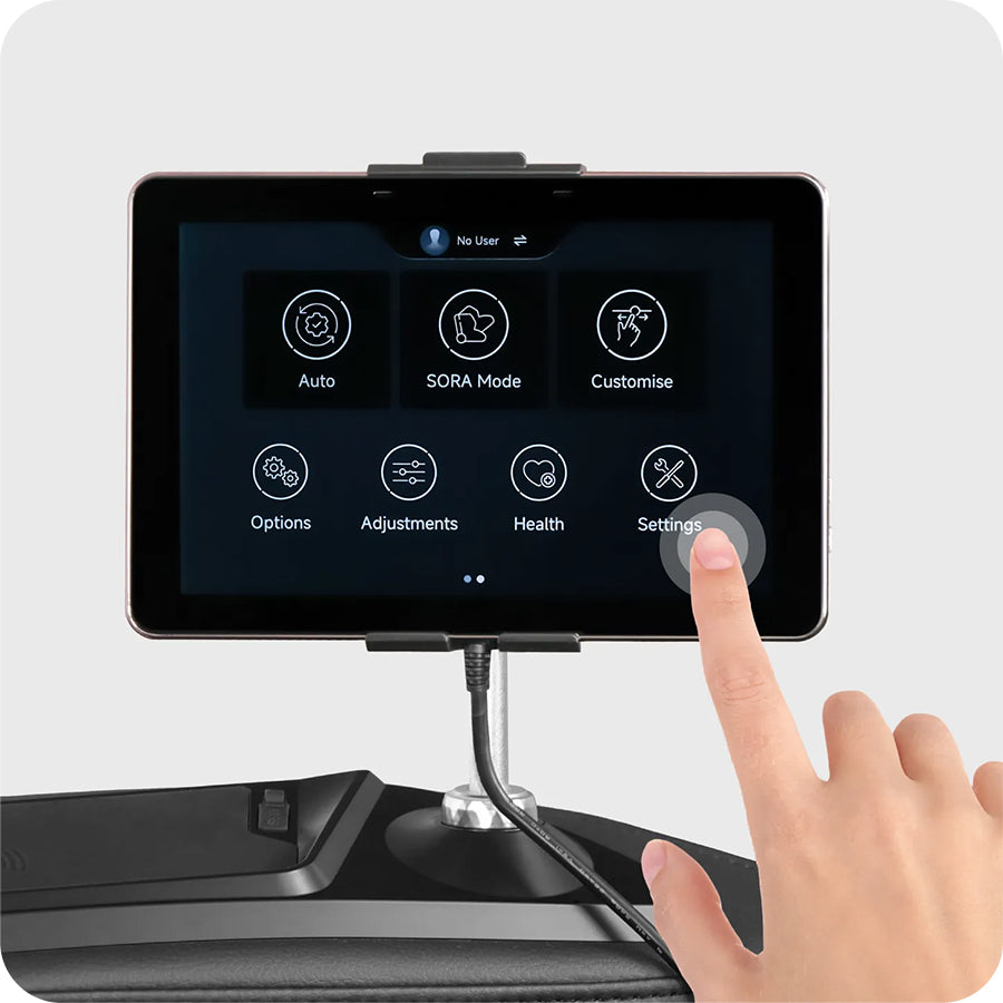 Osaki Trion Flex Duo 4D+3D Massage Chair in black. Hand selecting settings on tablet with intuitive touch controls.